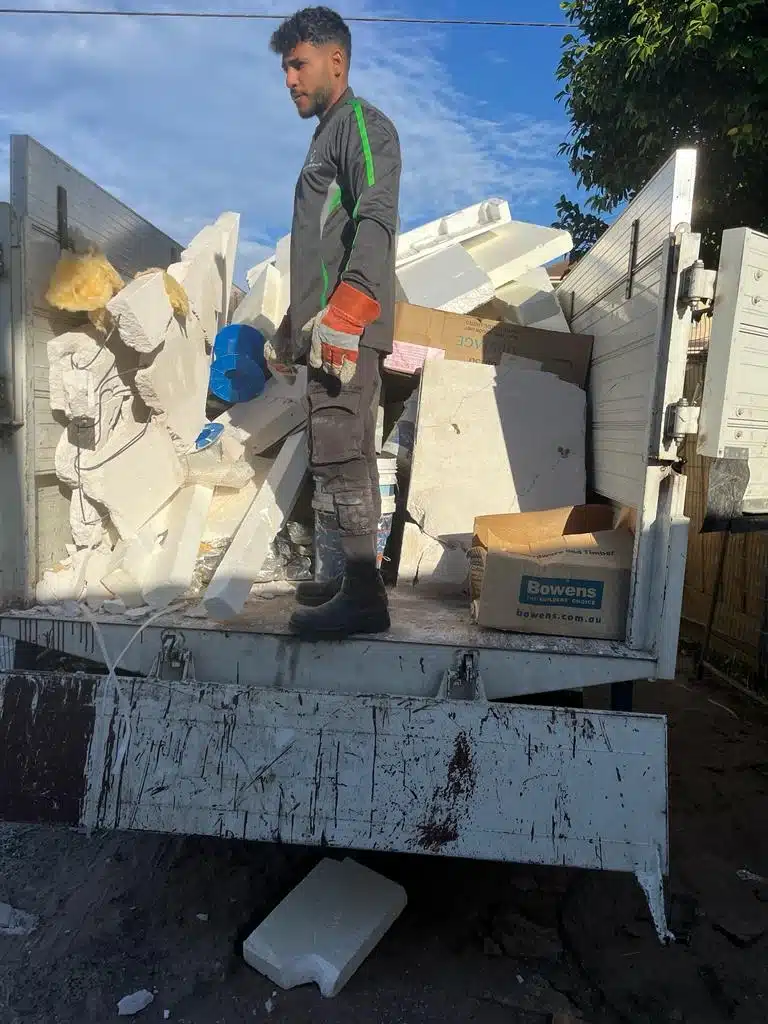 Rubbish Removal M8 team member loading rubbish into a truck in Melbourne