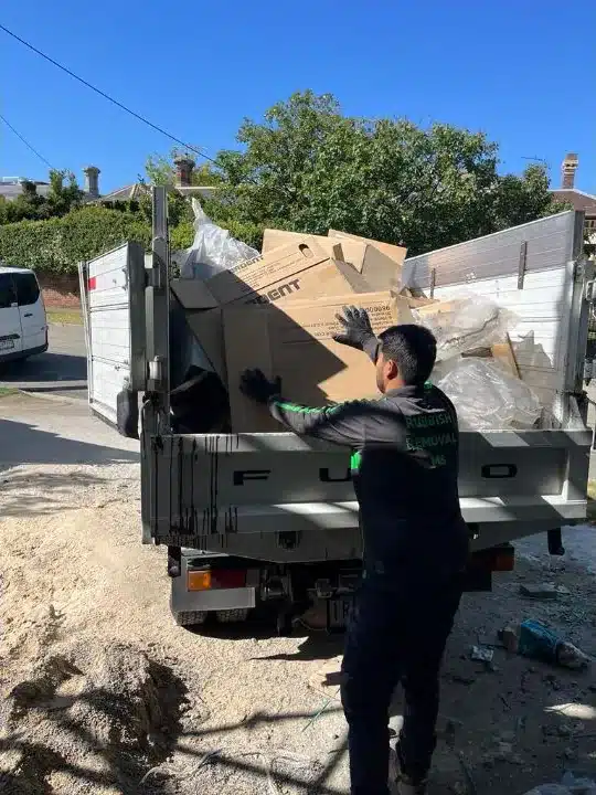 Rubbish Removal M8 team loading boxes and debris into a truck at a Melbourne job